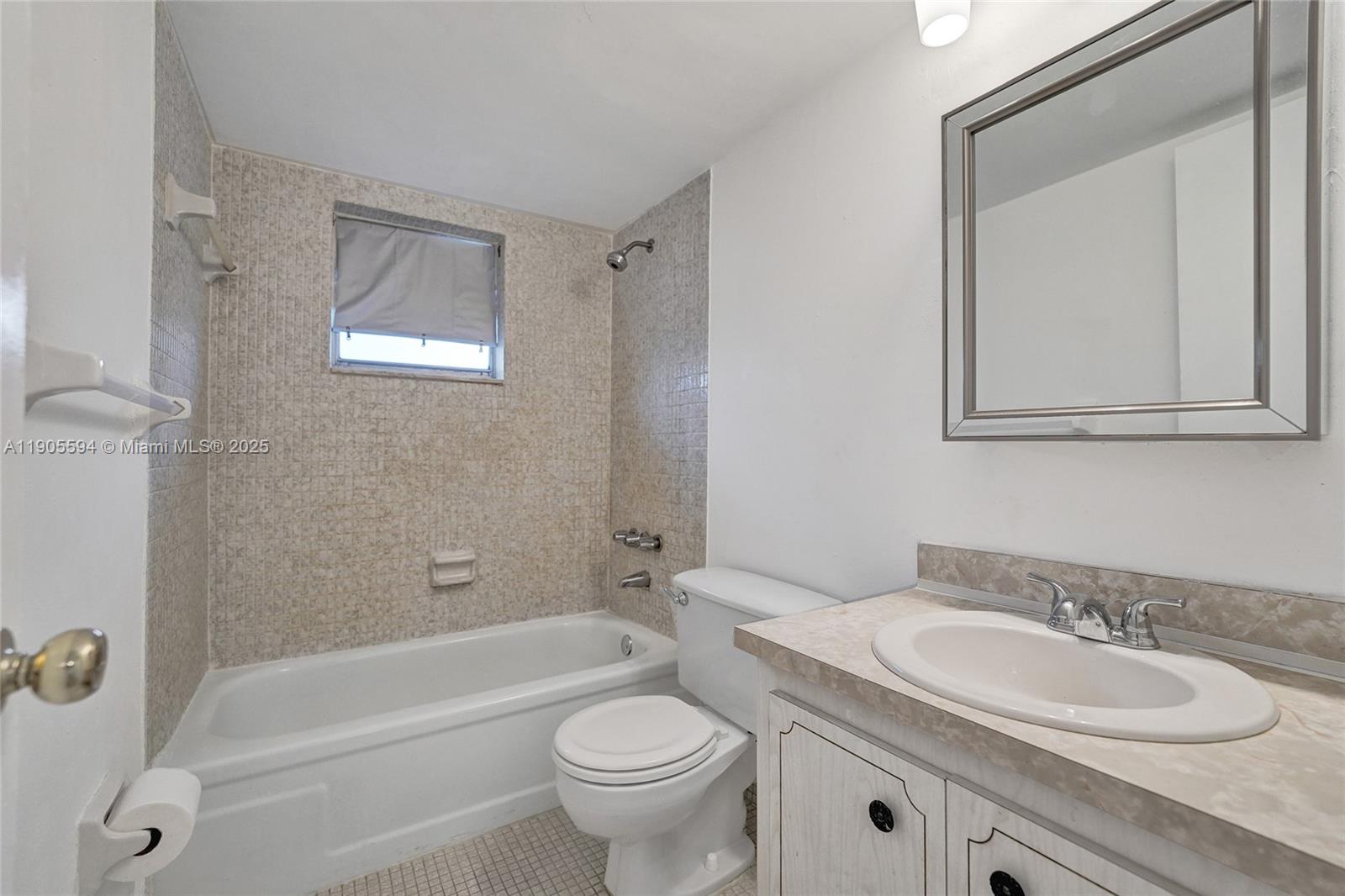 7541 Northwest 16th Street, Unit 1310 Plantation, FL 33313 - Photo 32 of 46 a bathroom with a granite countertop sink a toilet and a bathtub