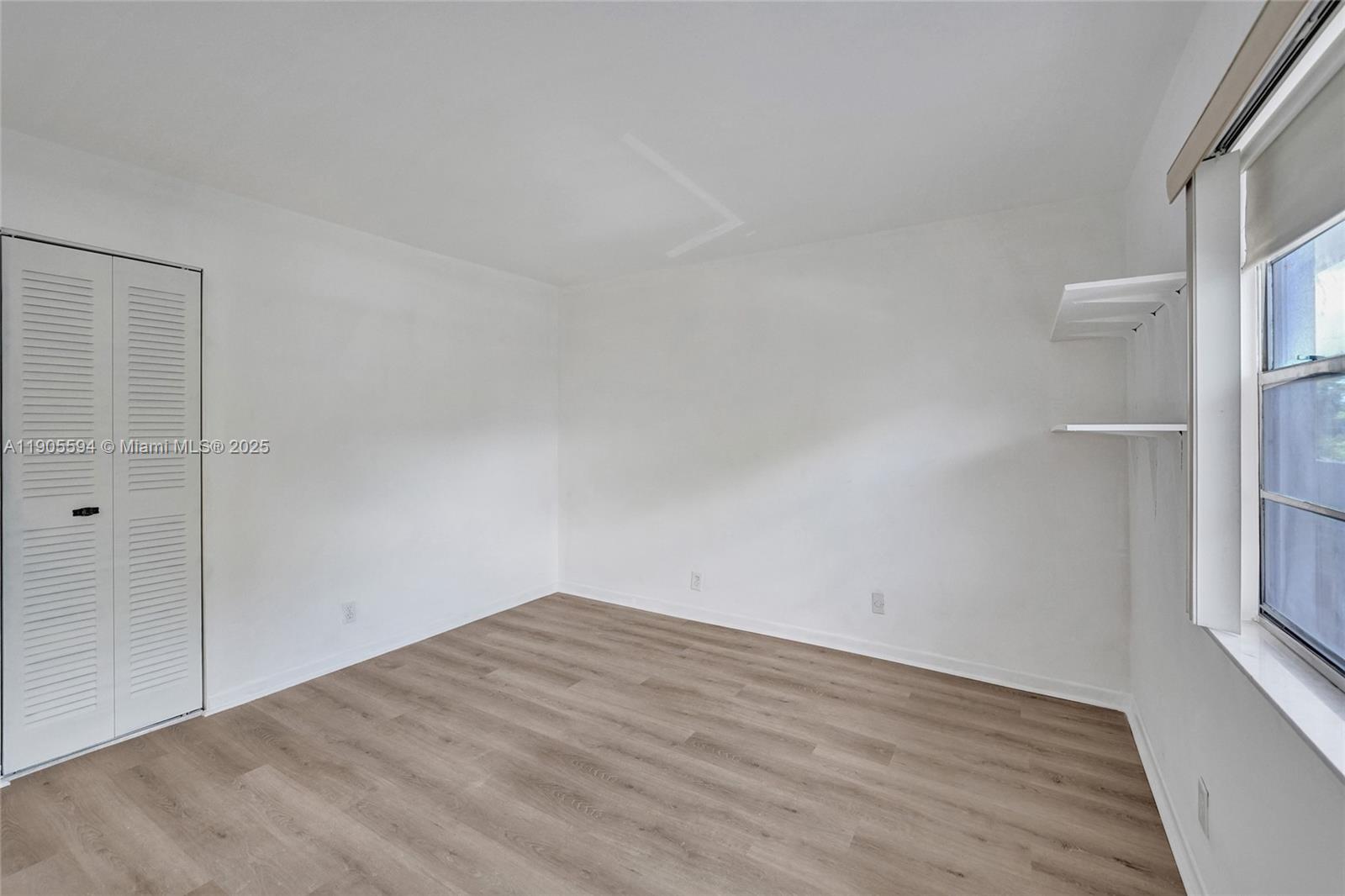 7541 Northwest 16th Street, Unit 1310 Plantation, FL 33313 - Photo 33 of 46 a view of empty room with wooden floor and fan