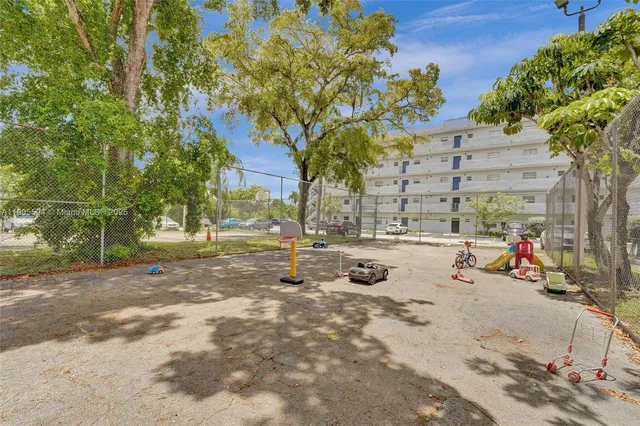 a view of a cars parked on the side of a street