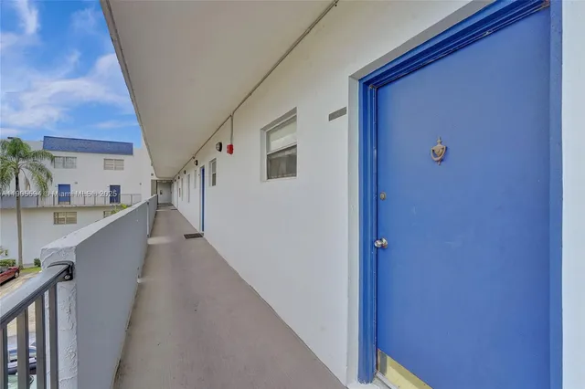 a view of a hallway with wooden floor and stairs