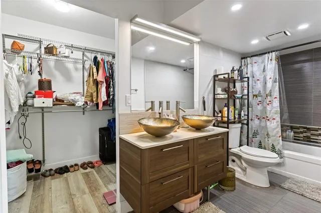 a bathroom with a toilet a sink and a mirror