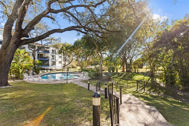 a patio with glass top table and chairs
