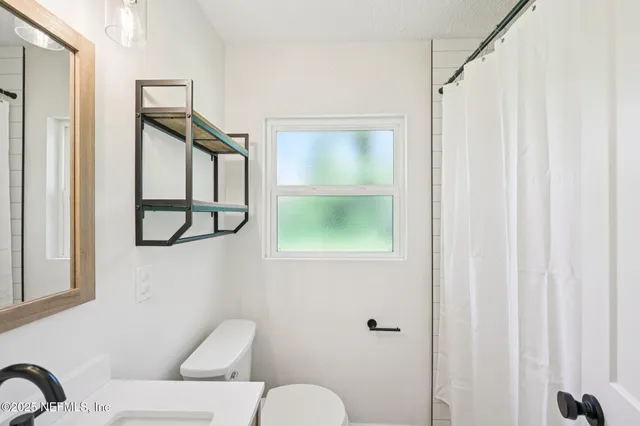 a bathroom with a toilet sink and tub