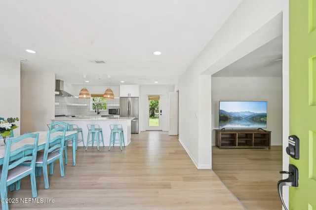 a view of a dining room kitchen with furniture and wooden floor