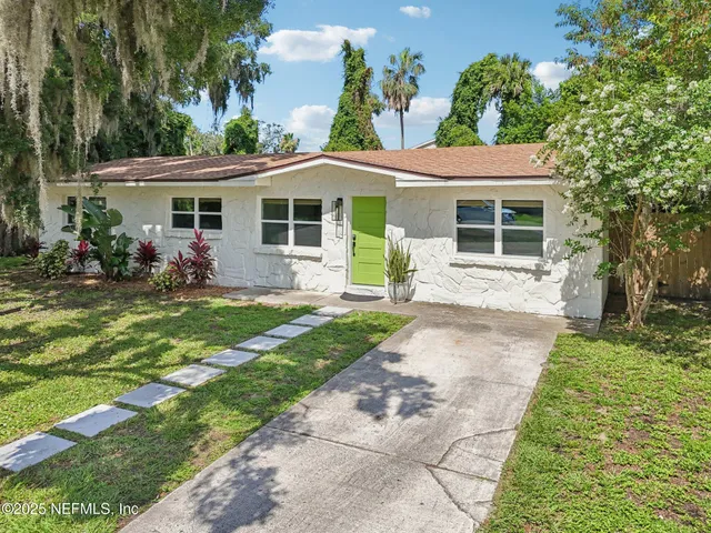 a front view of house with yard and green space