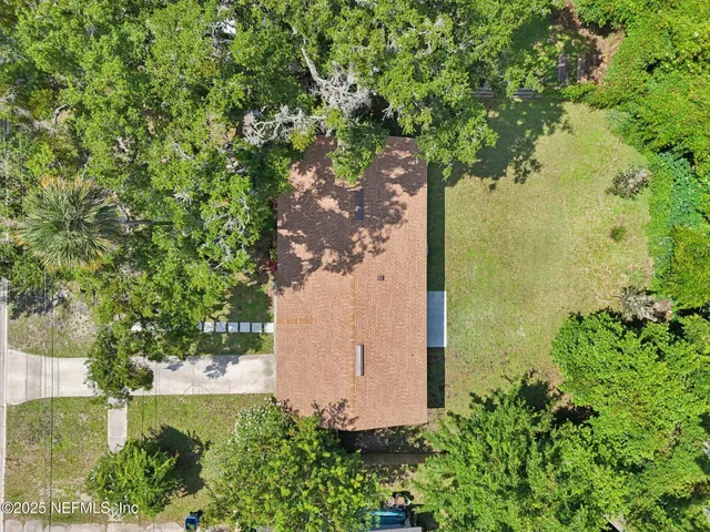 an aerial view of a house with a yard