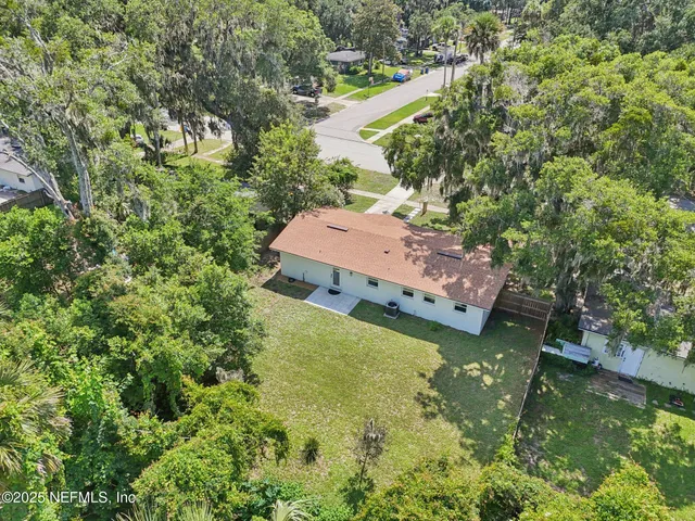 an aerial view of a house with yard swimming pool and outdoor seating