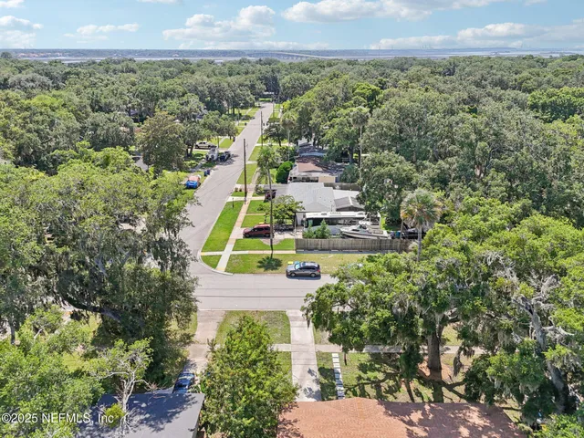 a view of a city with lush green forest