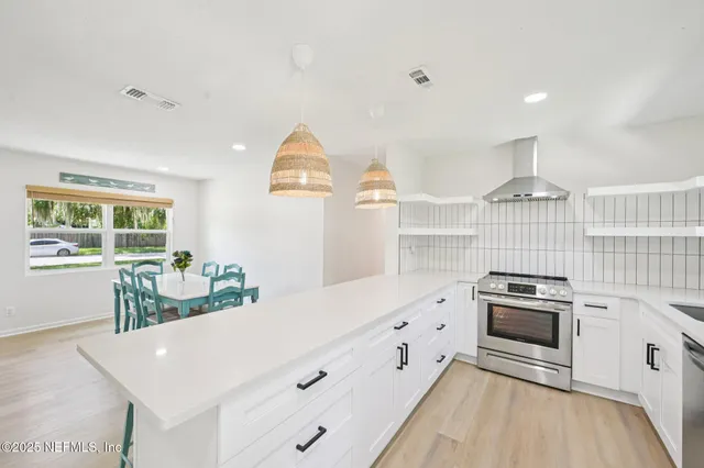 a kitchen with granite countertop a stove and a sink