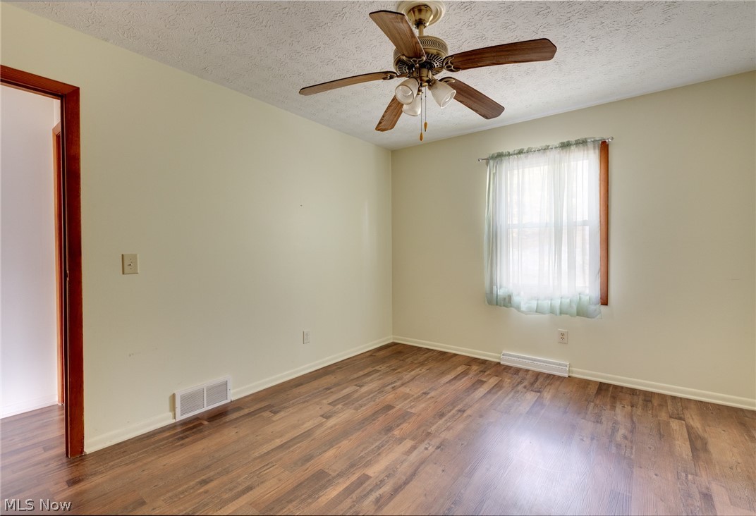 9416 Kieffer Road Mantua, OH 44255 - Photo 23 of 29 Bedroom with a textured ceiling, wood style floors, and ceiling fan