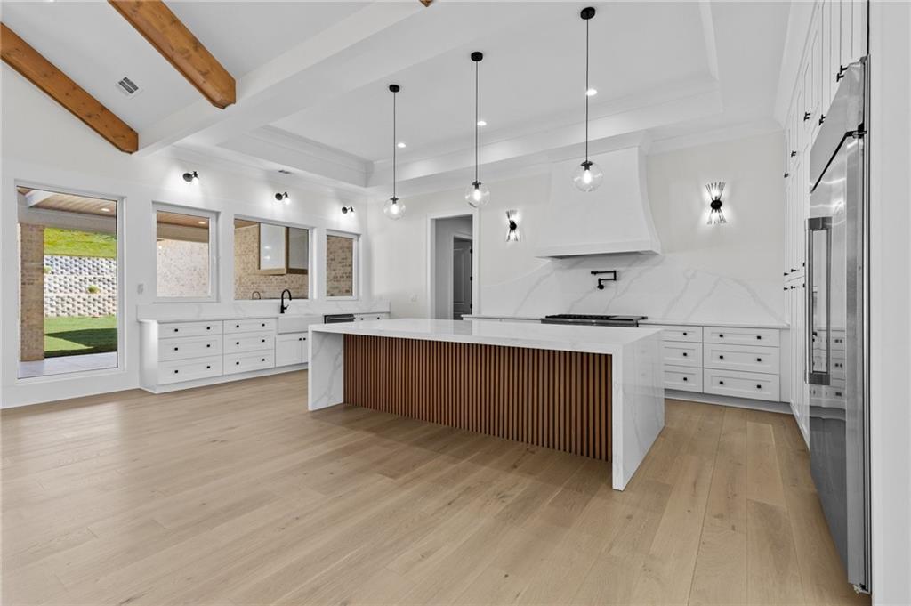 4521 Jack Pittman Road Monroe, GA 30656 - Photo 22 of 78 a large kitchen with stainless steel appliances kitchen island a large counter top and a wooden floors