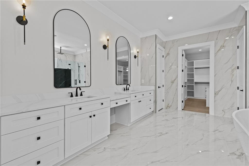 4521 Jack Pittman Road Monroe, GA 30656 - Photo 34 of 78 a large bathroom with a double vanity sink a large mirror and shower