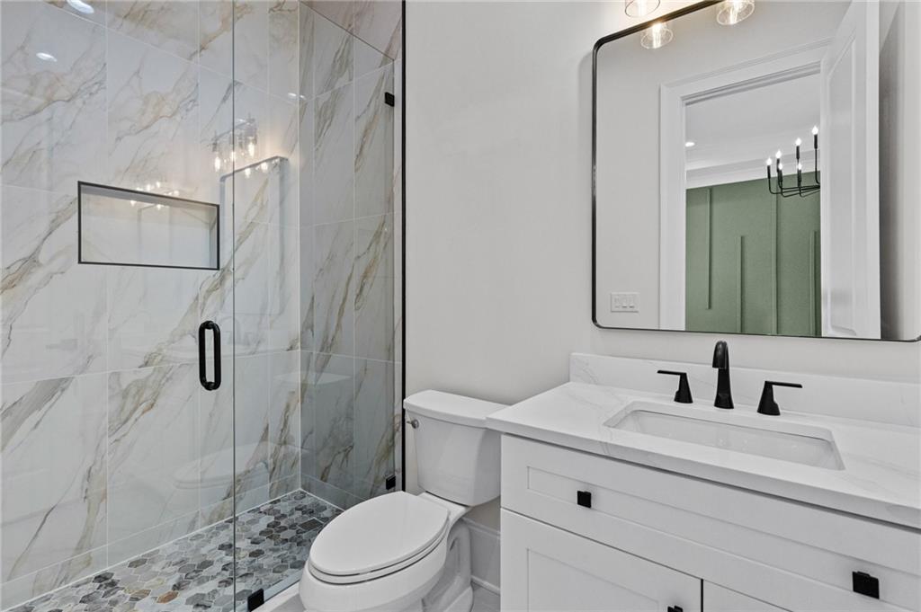 4521 Jack Pittman Road Monroe, GA 30656 - Photo 35 of 78 a bathroom with a sink a toilet and shower