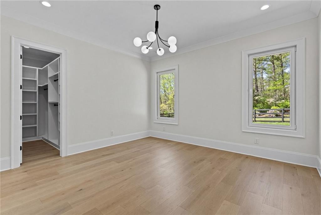 4521 Jack Pittman Road Monroe, GA 30656 - Photo 38 of 78 a view of an empty room with wooden floor and a window