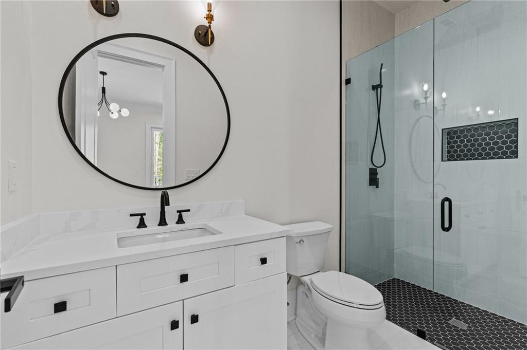 4521 Jack Pittman Road Monroe, GA 30656 - Photo 41 of 78 a bathroom with a sink a toilet and a mirror