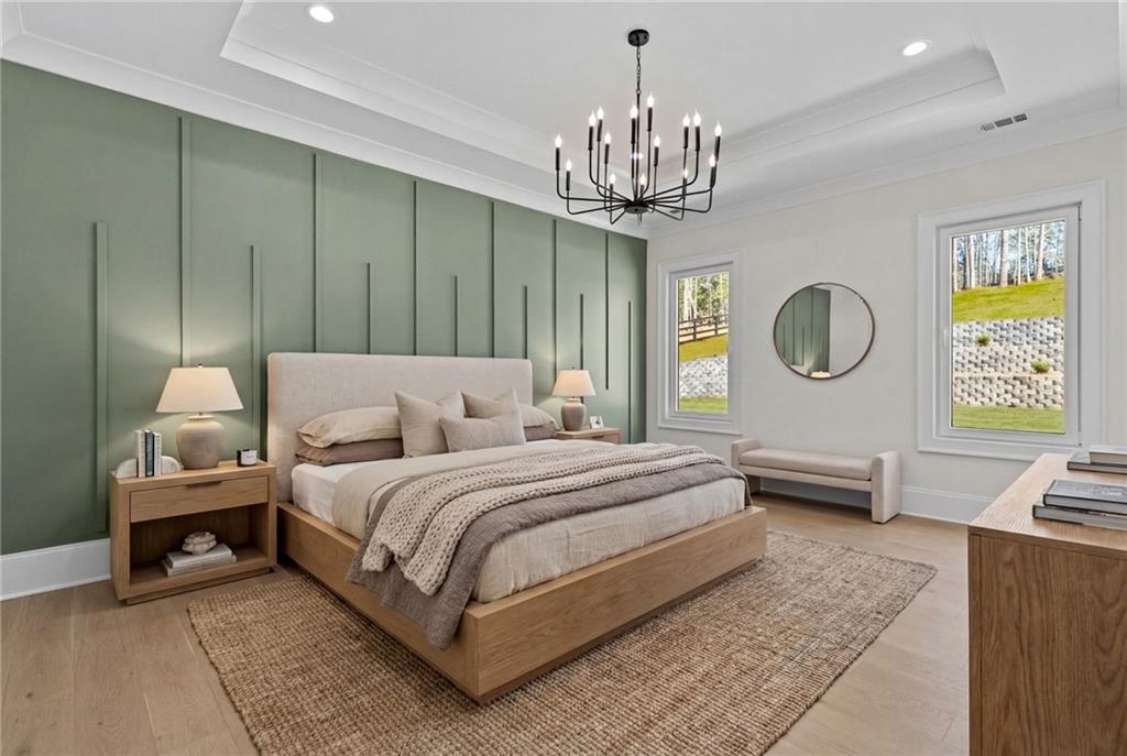 4521 Jack Pittman Road Monroe, GA 30656 - Photo 44 of 78 a spacious bedroom with a bed a chandelier and a dresser