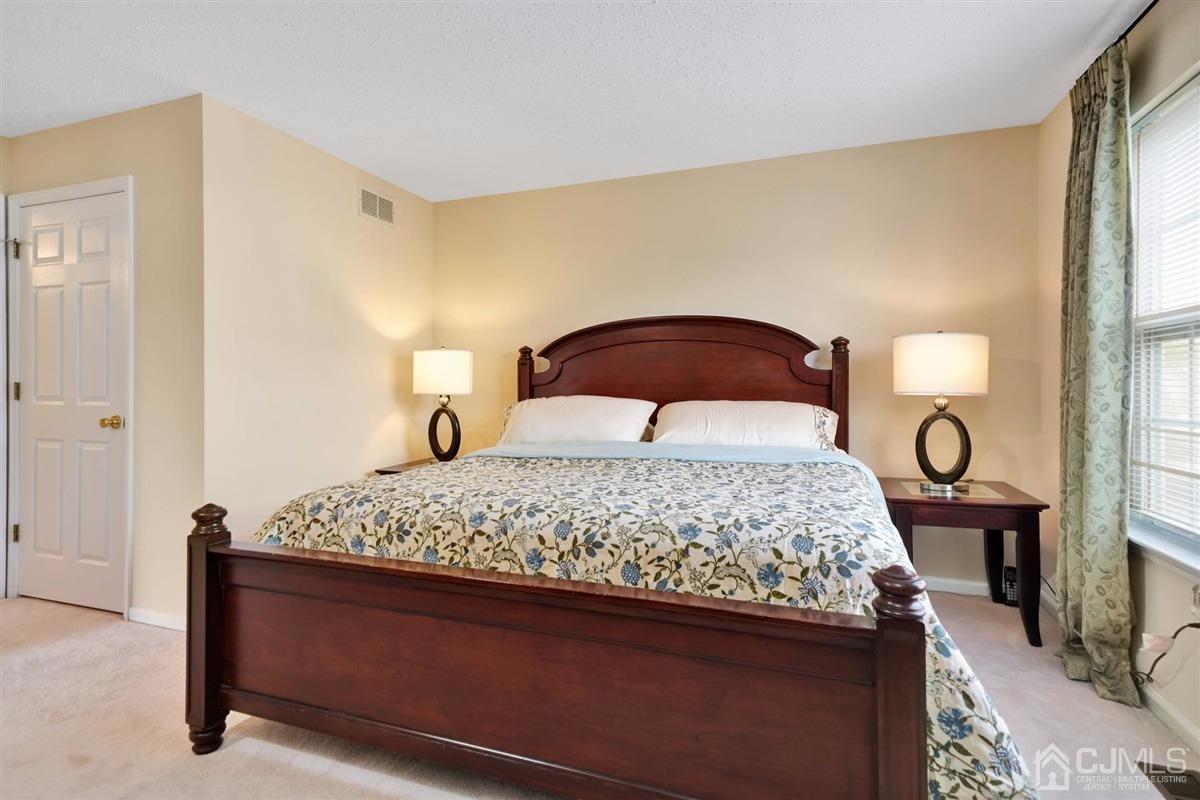 1 Prestwick Way, Unit 1 Edison, NJ 08820 - Photo 16 of 24 a bedroom with a bed and wooden floor