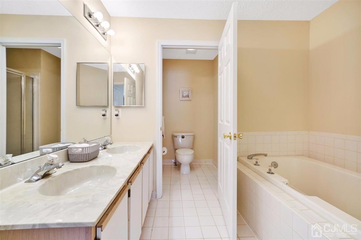 1 Prestwick Way, Unit 1 Edison, NJ 08820 - Photo 17 of 24 a bathroom with a sink a toilet and shower