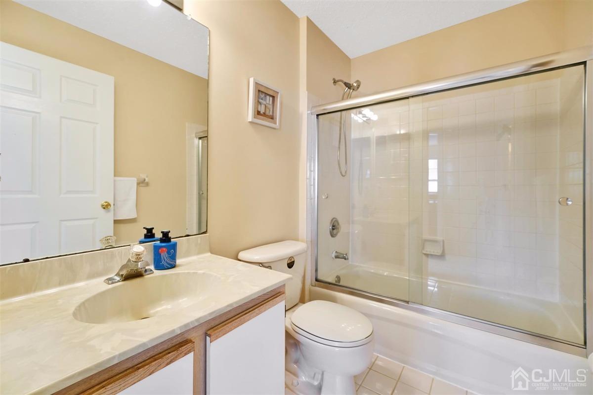 1 Prestwick Way, Unit 1 Edison, NJ 08820 - Photo 20 of 24 a bathroom with a sink and a mirror