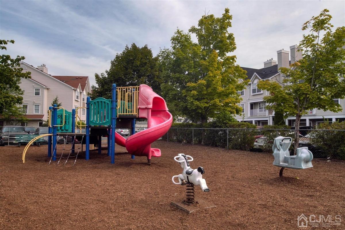 1 Prestwick Way, Unit 1 Edison, NJ 08820 - Photo 23 of 24 a view of a backyard with table and chairs
