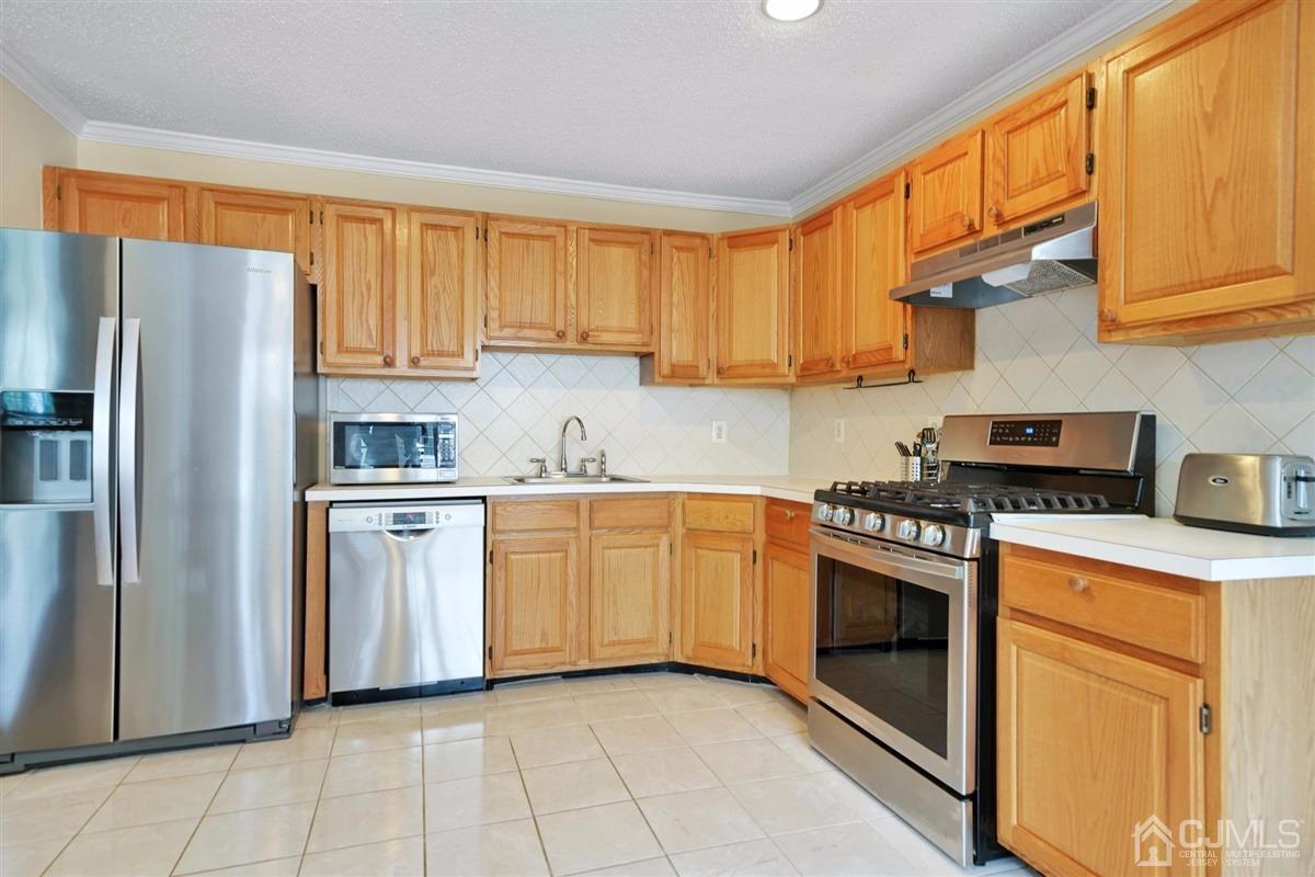 1 Prestwick Way, Unit 1 Edison, NJ 08820 - Photo 7 of 24 a kitchen with stainless steel appliances granite countertop a stove a sink and a refrigerator