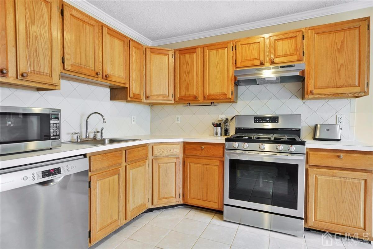 1 Prestwick Way, Unit 1 Edison, NJ 08820 - Photo 8 of 24 a kitchen with stainless steel appliances granite countertop a sink and cabinets