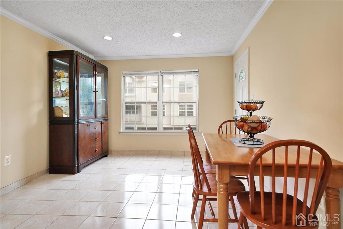 1 Prestwick Way, Unit 1 Edison, NJ 08820 - Photo 10 of 24 a view of a dining room with furniture window and outside view