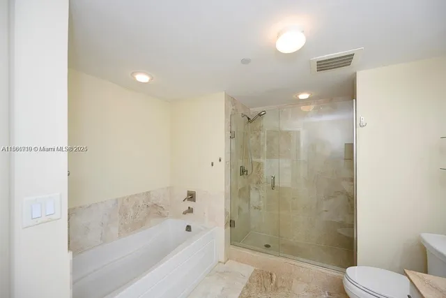 a bathroom with a shower and a toilet