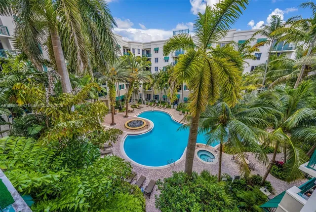an aerial view of a house with a swimming pool and garden