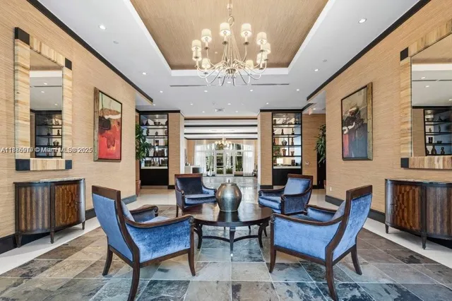 a living room with furniture a chandelier a large window and a chandelier