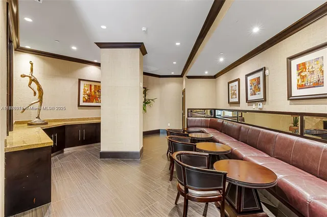 a dining room with furniture and a kitchen