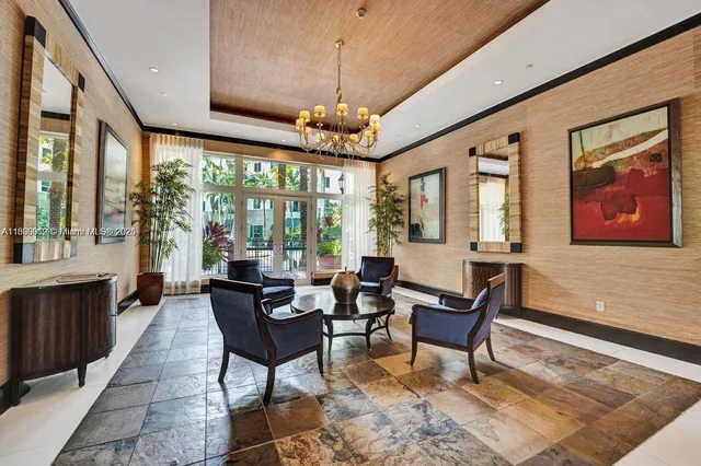 a living room with furniture and a chandelier