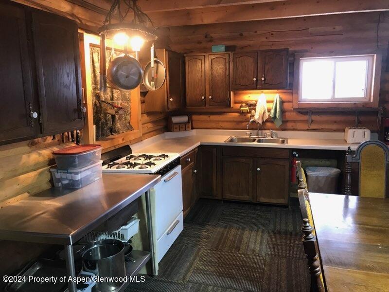80 Sapling Lane Craig, CO 81625 - Photo 23 of 27 a kitchen with wooden cabinets and a sink