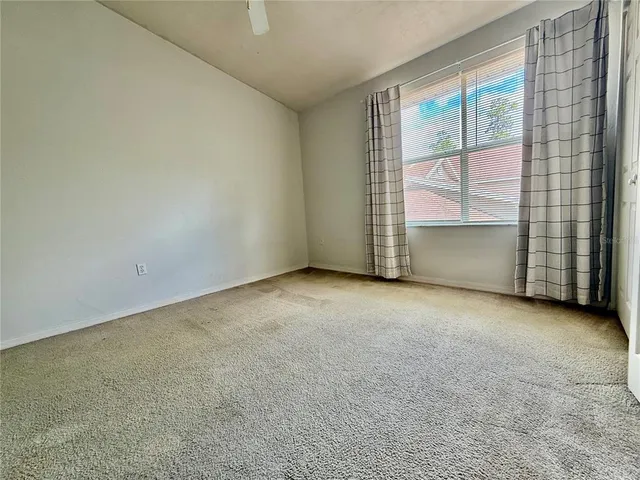 an empty room with a fireplace and a window