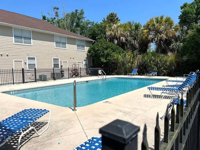 a view of a house with backyard and sitting area