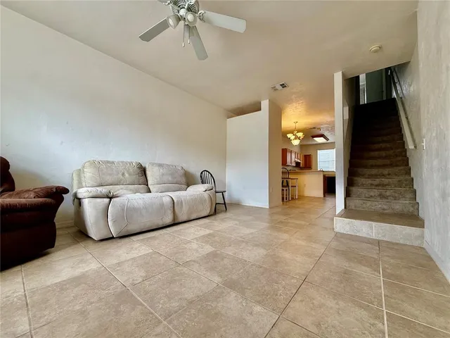 a living room with furniture and stairs
