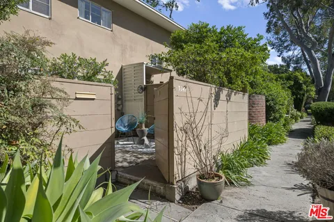 a view of a backyard with plants and entertaining space