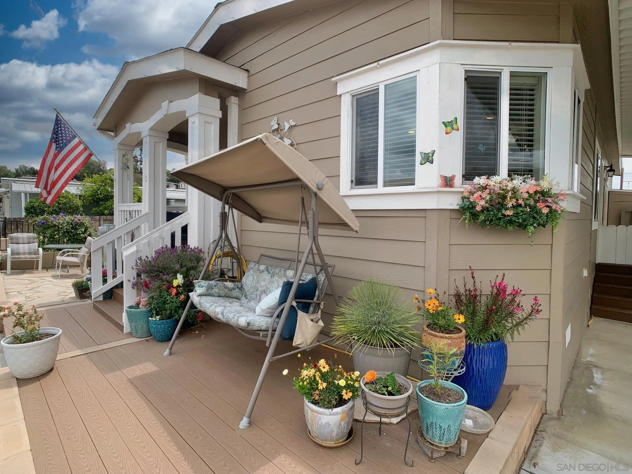 a view of a patio with chairs and potted plants