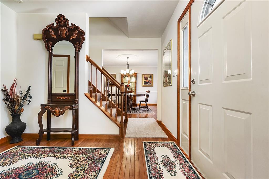 1069 Redoak Drive Harrison City, PA 15636 - Photo 15 of 43 a view of staircase with wooden floor and a rug