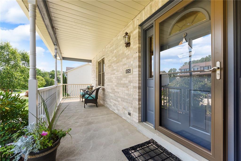 1069 Redoak Drive Harrison City, PA 15636 - Photo 3 of 43 a view of a porch with chairs and potted plants