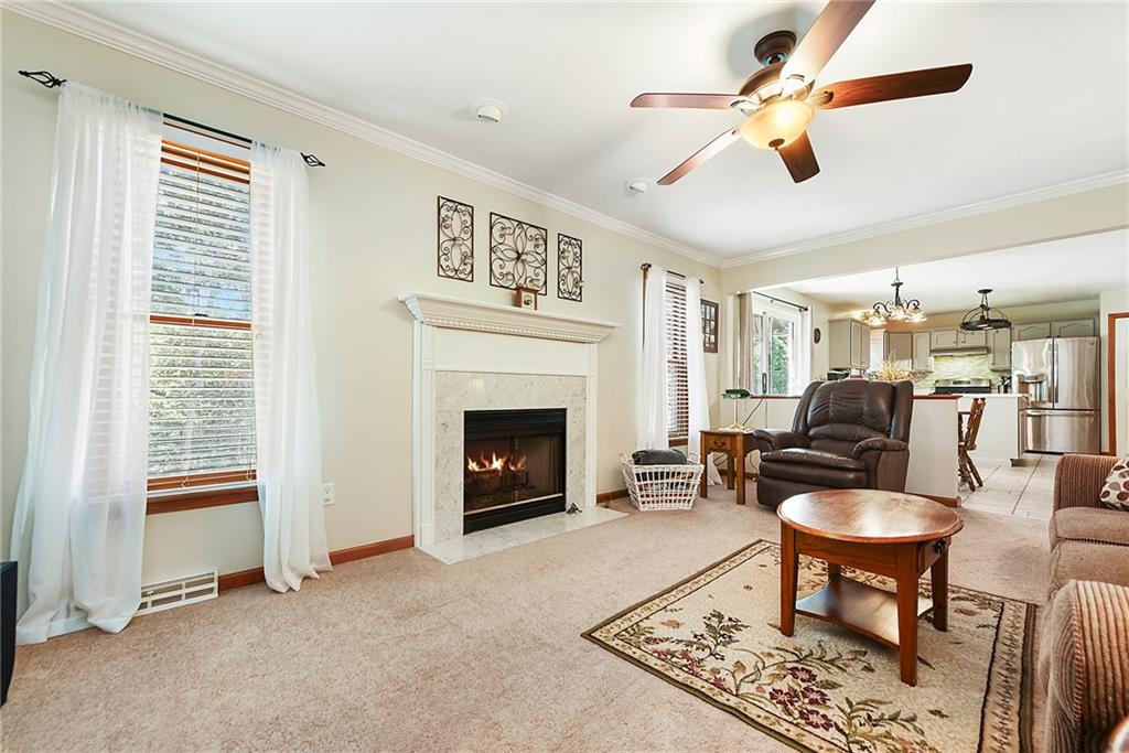 1069 Redoak Drive Harrison City, PA 15636 - Photo 5 of 43 a living room with furniture a fireplace and a window