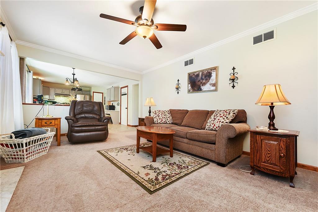 1069 Redoak Drive Harrison City, PA 15636 - Photo 6 of 43 a living room with furniture and a chandelier