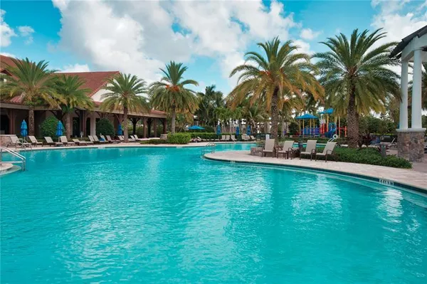 a view of a swimming pool with palm trees