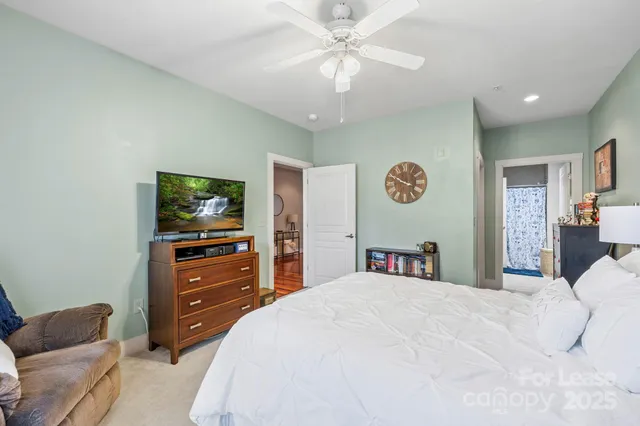 a bedroom with a bed and a television