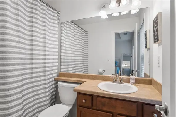 a bathroom with a sink a toilet and mirror