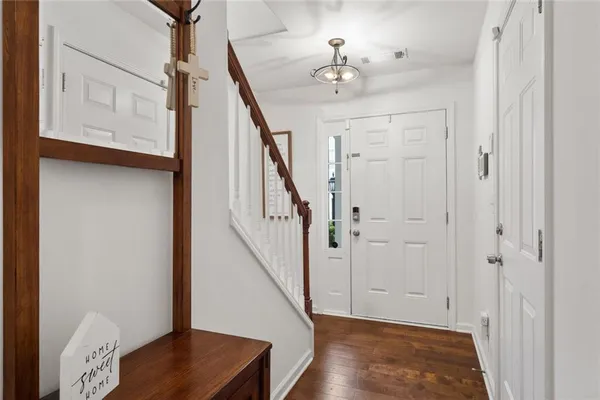 a view of entryway with stairs and wooden floor