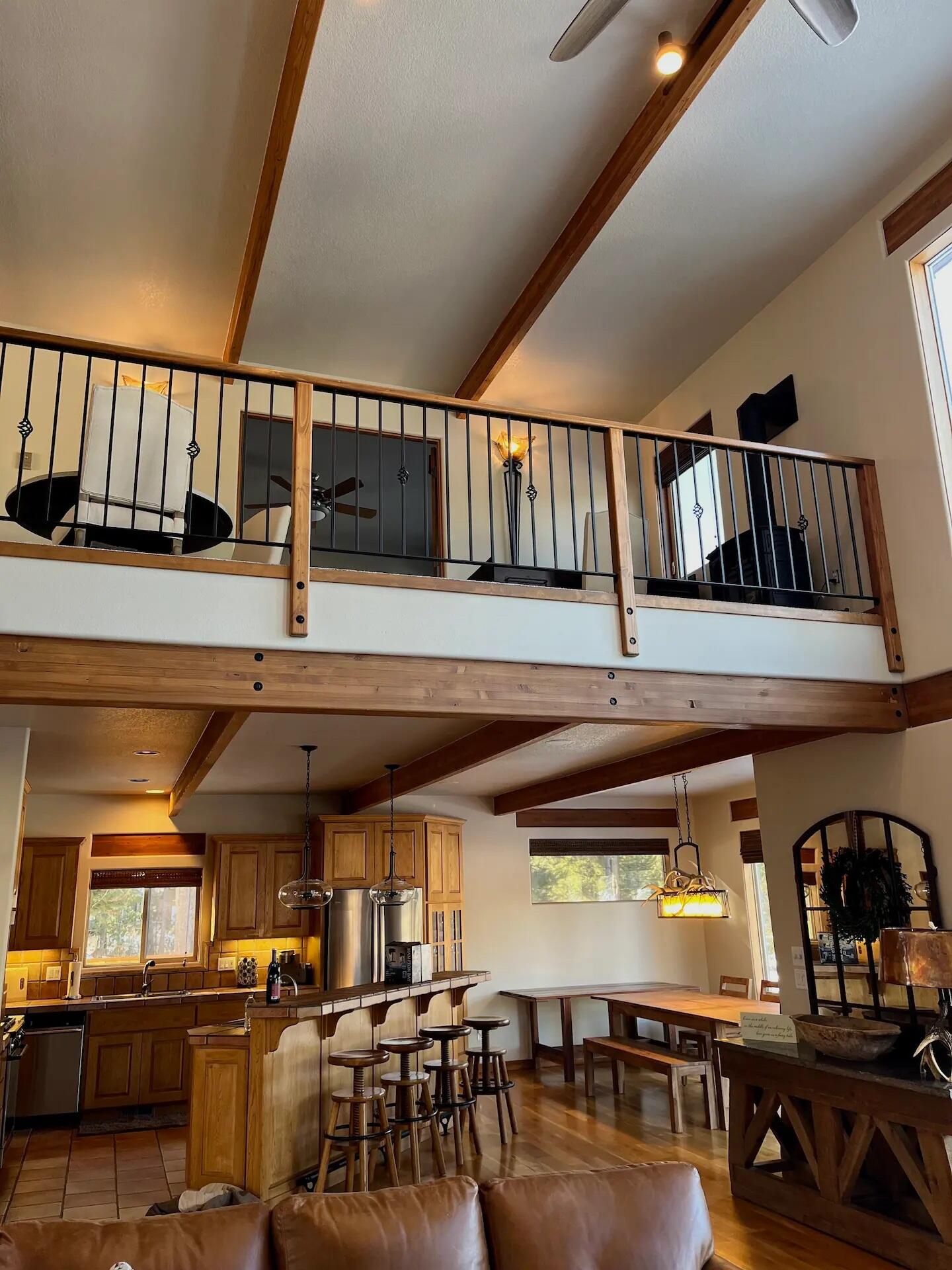 56065 Snow Goose Road Bend, OR 97707 - Photo 44 of 65 From main living looking up at second level loft area. Second master and work/ play space Looking into open chef's kitchen with Dacor high end new appliances.