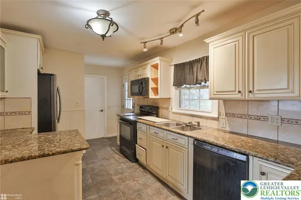 a kitchen with a sink stove and cabinets