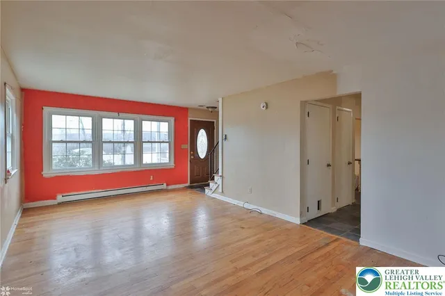a view of a livingroom with a ceiling fan and window