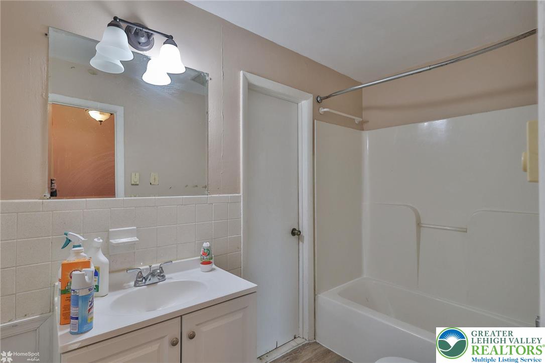 210 South 16th Street Emmaus, PA 18049 - Photo 44 of 71 a bathroom with a sink vanity granite tub shower and a mirror